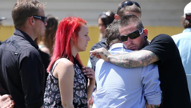 Friends and relative console each other after the funeral of Mark 'Zeb' Spencer at the Metropolitan Funeral Chapel in Southport. Picture: Glenn Hampson