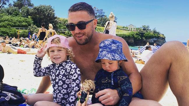 Burgess with his kids Poppy and Billy at Coogee Beach last year.