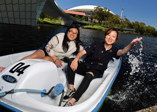 Chinese tourists Yuan Ma, 31, and Luo Zan, 25, enjoy a paddle on the River Torrens. Picture: Tom Huntley