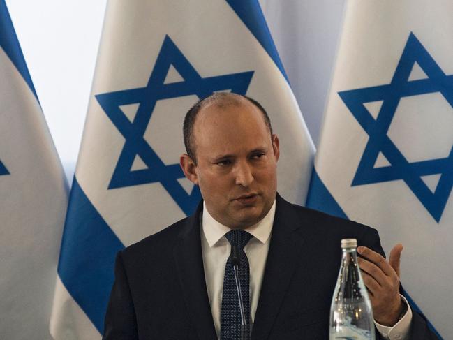 Israeli Prime Minister Naftali Bennett (C) heads the weekly cabinet meeting in Kibbutz Mevo Hama in the Israeli-annexed Golan Heights, on December 26, 2021. (Photo by NIR ELIAS / POOL / AFP)