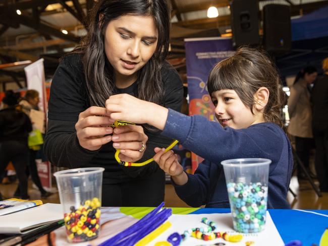 Brooklyn Gwilliams gets a hand from mum Shantelle Gwilliams on a craft stall at Toowoomba NAIDOC Week celebrations at The Goods Shed, Monday, July 4, 2022. Picture: Kevin Farmer