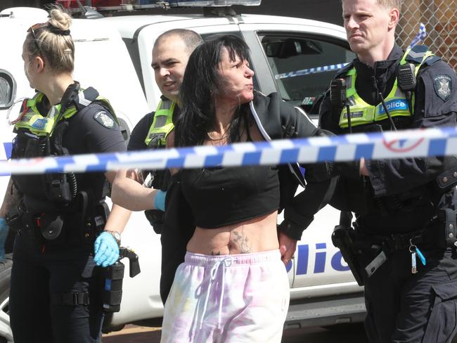 Police lead Preston’s fiance Lauran Howe from the scene. Picture: David Crosling