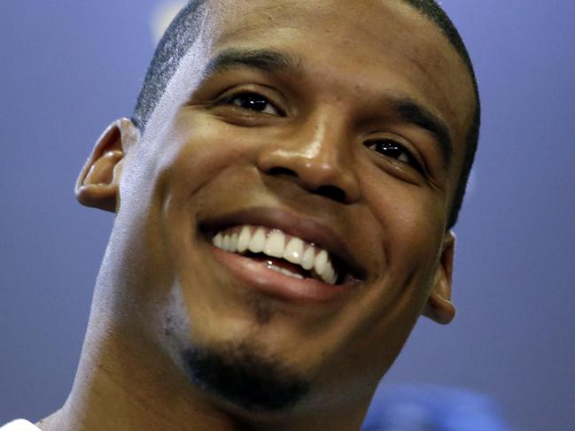 Carolina Panthers quarterback Cam Newton smiles as he answers questions during a press conference Tuesday, Feb. 2, 2016 in San Jose, Calif. Carolina plays the Denver Broncos in the NFL Super Bowl 50 football game Sunday, Feb. 7, 2015, in Santa Clara, Calif. (AP Photo/Marcio Jose Sanchez)