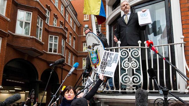 Julian Assange (C) addresses media and supporters from the balcony of Ecuador's embassy in central London, in 2016. Picture: AFP.