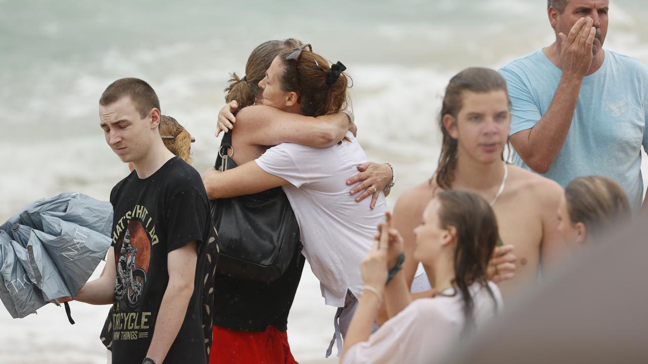 Family and friends of 16-year-old alleged stabbing victim Balin Stewart gather to pay tribute on his home beach at Buddina. Picture: Lachie Millard