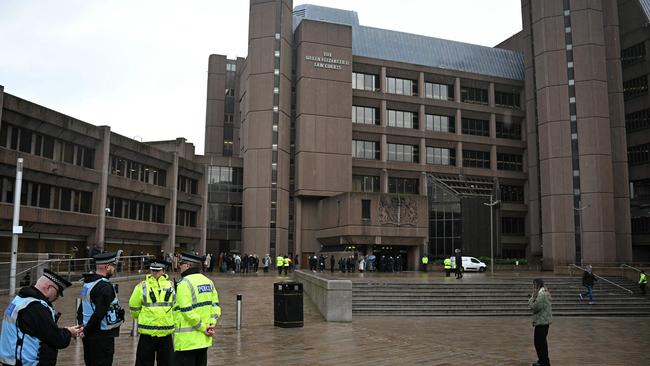 Police officers stand on duty outside The Queen Elizabeth II Law Courts in Liverpool, north west England on January 20, 2025, as people arrive ahead of the trial Southport attacker Axel Rudakubana. (Photo by Paul ELLIS / AFP)