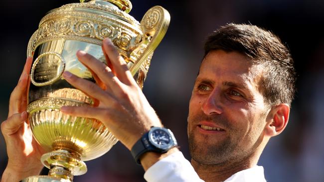 Novak Djokovic of Serbia holds the trophy following his victory against Nick Kyrgios of Australia during their Men's Singles Final match on day fourteen of The Championships Wimbledon 2022 at All England Lawn Tennis and Croquet Club on July 10, 2022 in London, England. (Photo by Clive Brunskill/Getty Images)