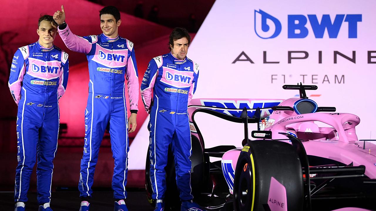 (From L) Alpine F1 team's drivers, Australian Oscar Piastri, French Esteban Ocon and Spanish Fernando Alonso, pose during the unveiling of Alpine F1 team's A522 new racing car for the upcoming Formula One 2022 season at the Palais de Tokyo in Paris on February 21, 2022, two days before the first pre-season track session of the year at the Circuit de Barcelona-Catalunya. - The A522 will be raced this year by Fernando Alonso and Esteban Ocon, whoâ&#128;&#153;ll team up for a second season at Alpine. (Photo by FRANCK FIFE / AFP)