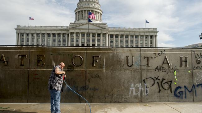 Cleaning up graffiti at the Capitol in Salt Lake City on Sunday. Picture: Jeremy Harmon/The Salt Lake Tribune via AP