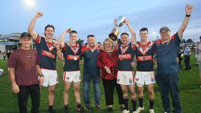 From left to right: Mick Clements, Oliver Clements, Finn Douch, Warren Douch, Sandra Besley, Zade Besley, Toby Elliott and John Elliott celebrate Erina’s win. Picture: Sue Graham