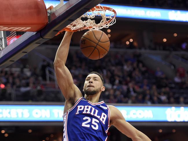 Philadelphia 76ers guard Ben Simmons dunks over Washington Wizards guard Tim Frazier, rear, during the first half of an NBA basketball game, Wednesday, Oct. 18, 2017, in Washington. (AP Photo/Nick Wass)