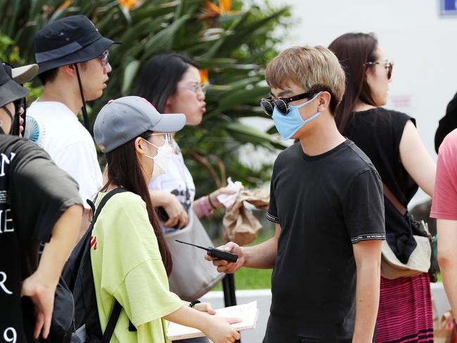 Tourists wearing masks in Surfers Paradise on the Gold Coast. Picture: Nigel Hallett