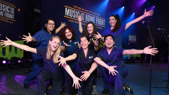 Royal Melbourne Hospital Scrub Choir will sing at the Music From the Home Front concert at the Myer Music Bowl on Anzac Day eve. (L-R) Benjamin Sutu (back), Anita Ayling, Emma O’Brien, Nadia Millar (front), Olivia O’Brien, Jasper Castillo (front) and Ana Suto. Picture: Josie Hayden