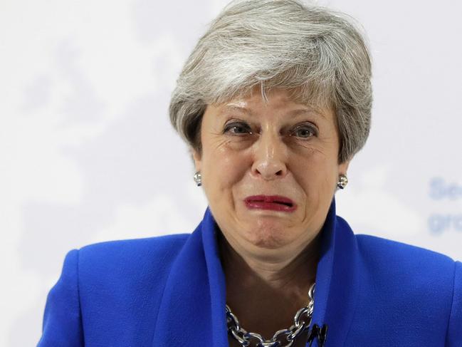 Britain's Prime Minister Theresa May grimaces as she delivers a keynote speech in central London on May 21, 2019. - British Prime Minister Theresa May on Tuesday outlined a series of incentives for MPs to support her Brexit deal, saying there was "one last chance" to end the deadlock. May called the draft legislation going before MPs next month a "new Brexit deal" to end the current political impasse which has delayed Brexit. (Photo by Kirsty Wigglesworth / POOL / AFP)