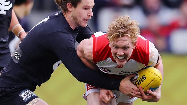 Clayton Oliver tries to break through the tackle of Carlton’s Bryce Gibbs. Picture: Michael Klein