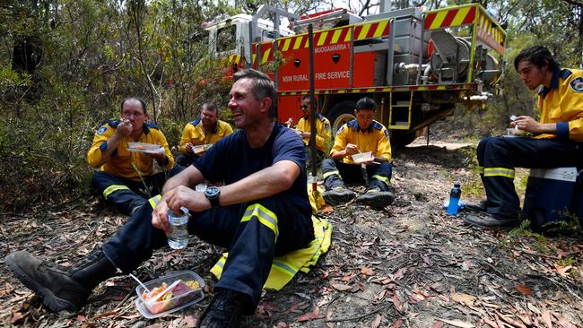 Rural Fire Service captain Wayne Everett, front, and his crew enjoy Christmas lunch near Bilpin, NSW, during a cool reprieve from the bushfire crisis. Picture: Sam Mooy