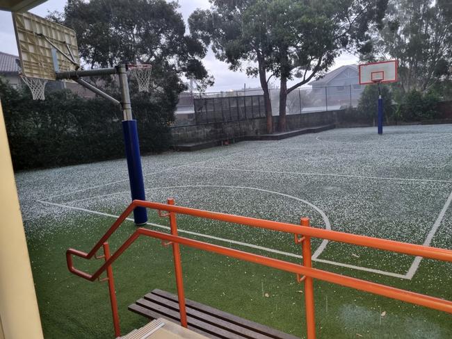 Hail blanketed a basketball court at Bondi.