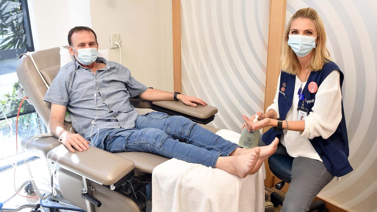 Craig Faninges about to receive a foot massage from volunteer Paulien Robinson. Ms Robinson survived being hit by a truck while riding a motorbike but the injuries left her with a brain injury and unable to return to work, but she has found joy in volunteering at a hospital. Picture: Patrick Woods.