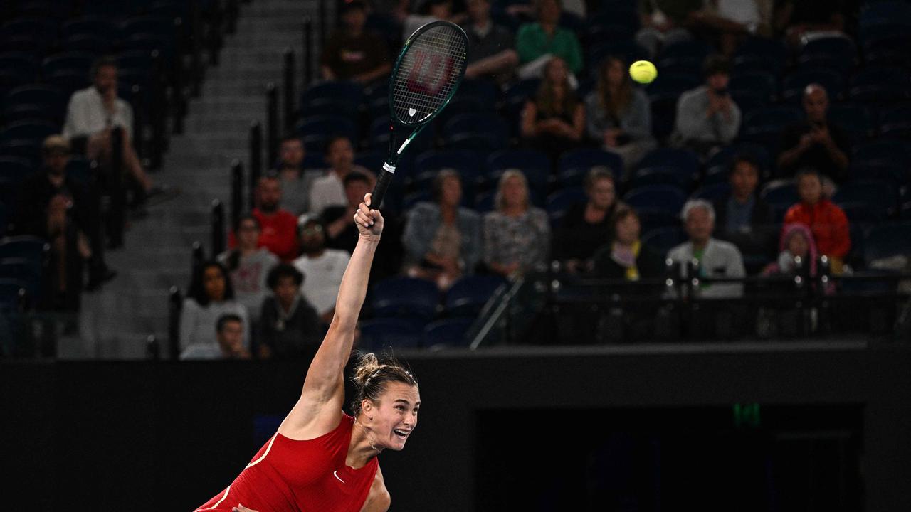 Sabalenka gets the match underway to a host of empty seats. (Photo by Anthony WALLACE / AFP)