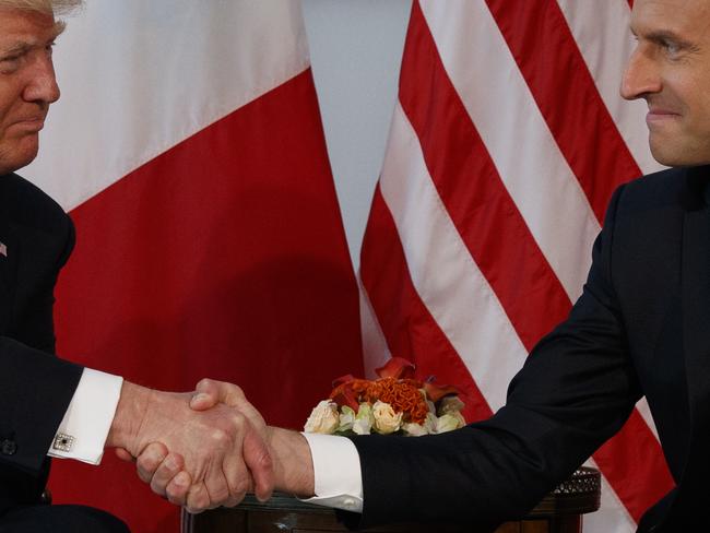 Mr Trump and Mr Macron pictured during that handshake moment last week during a meeting at the US Embassy in Brussels. Picture: Evan Vucci/AP