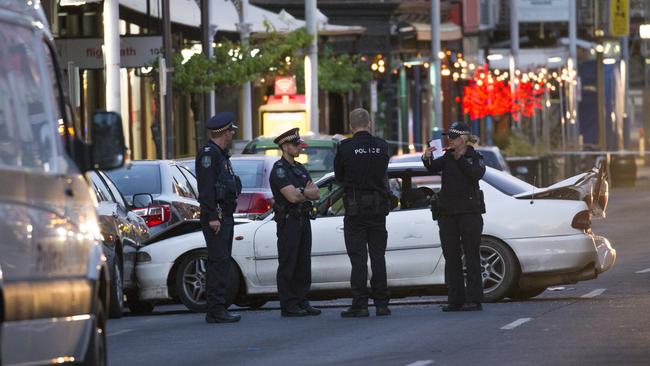 Police officers near the car driven by Hall before he was shot in Hindley St. Picture: Scott Oates