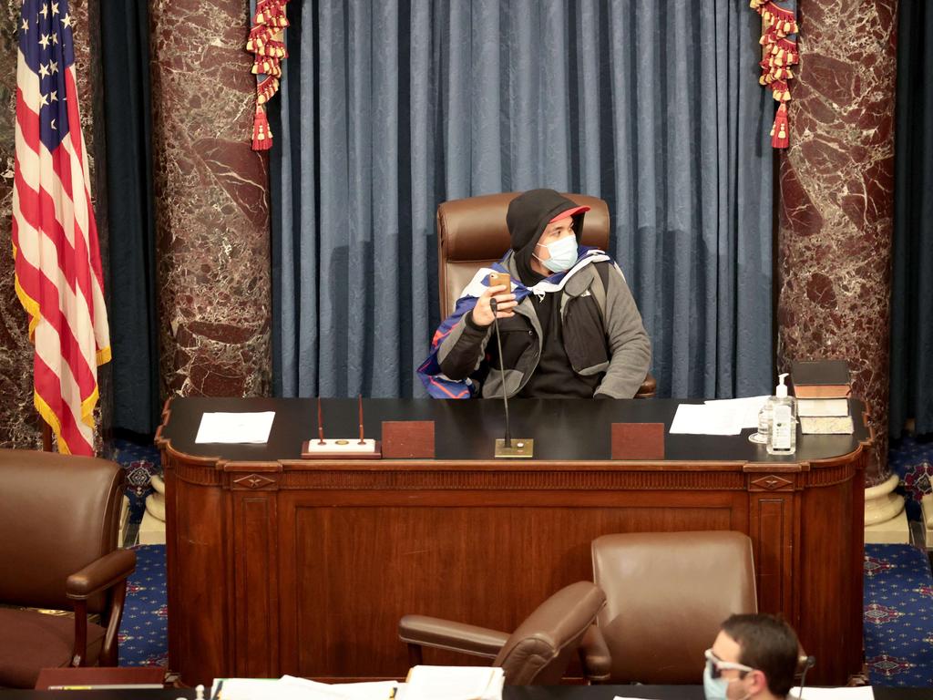 A protester sits in the Senate Chamber on January 06, 2021 in Washington, DC. Picture: Getty