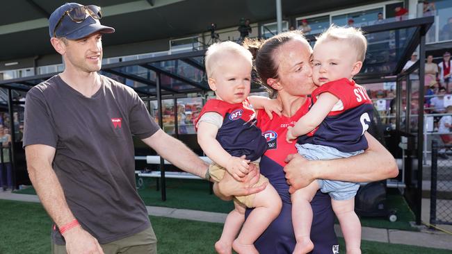 Daisy Pearce of the Demons celebrates a win with son Roy and daughter Sylvie.