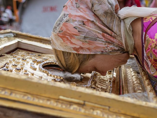 A woman prays next to a copy of the jewel encrusted Kasperovskaya Mother of God icon recovered from inside the Historical Transfiguration Cathedral in Odessa, Ukraine, after the building was hit in a Russian missile attack. Picture: Andre Alves / Anadolu Agency via Getty Images