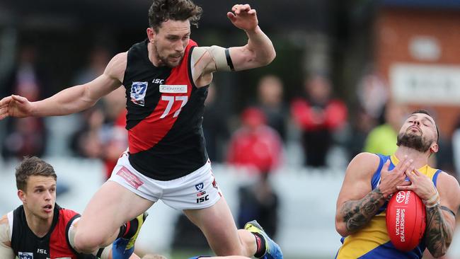 Williamstown’s Jake Greiser marks as Essendon’s Heath Hocking arrives later in the 2019 VFL finals.