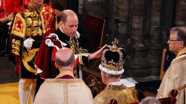 Prince William touches St Edward's Crown on the head of his father. Picture: AFP