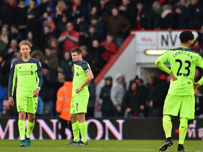 Liverpool's Brazilian midfielder Lucas Leiva (L), Liverpool's English midfielder James Milner and Liverpool's German midfielder Emre Can (R) react to their defeat on the pitch after the English Premier League football match between Bournemouth and Liverpool at the Vitality Stadium in Bournemouth, southern England on December 4, 2016. Bournemouth won the game 4-3. / AFP PHOTO / Glyn KIRK / RESTRICTED TO EDITORIAL USE. No use with unauthorized audio, video, data, fixture lists, club/league logos or 'live' services. Online in-match use limited to 75 images, no video emulation. No use in betting, games or single club/league/player publications. /