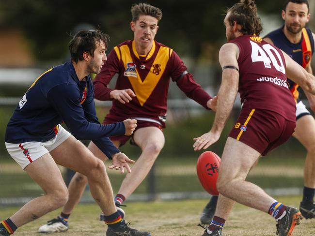 Caulfield top-liner Jacob Buggy gets away a handball.