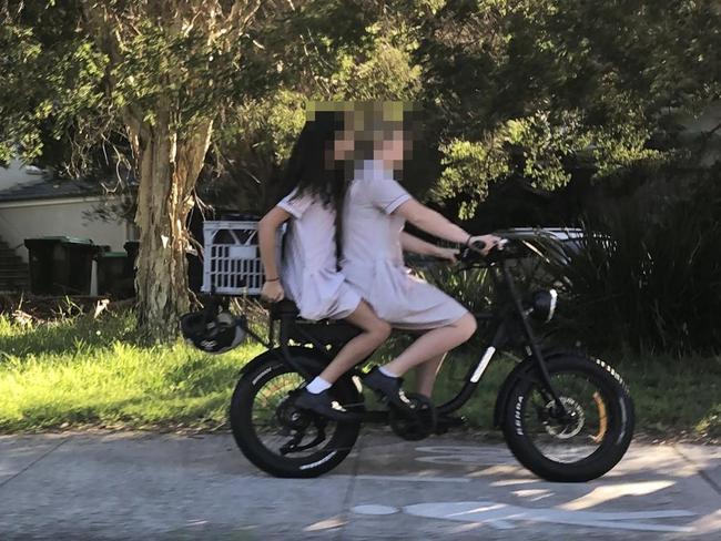 Secondary school students on an e-bike on a shared path in Manly, without helmets, where locals have been complaining about bikes speeding along footpaths at up to 30km/h. Picture: Jim O'Rourke