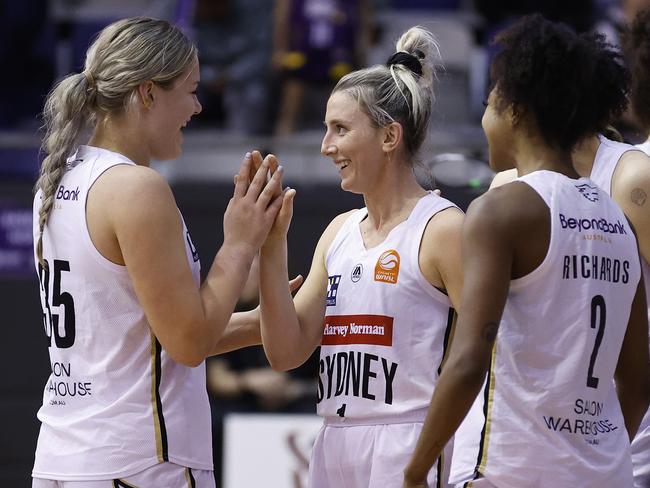 MELBOURNE, AUSTRALIA - DECEMBER 20: Lauren Nicholson of the Flames (C) and Isla Juffermans of the Flames celebrate winning the WNBL match between Melbourne Boomers and Sydney Flames at Melbourne Sports Centres - Parkville, on December 20, 2023, in Melbourne, Australia. (Photo by Daniel Pockett/Getty Images)