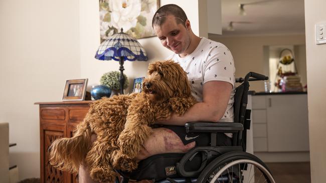 Brodie Ellis at home with his dog. Picture: Mark Cranitch.