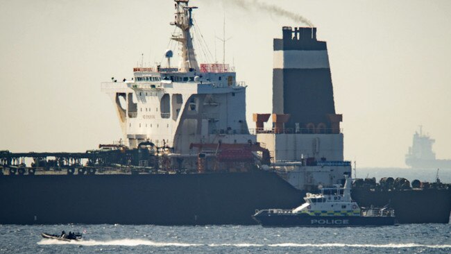 Royal Marine patrol vessel is seen beside  the Grace 1 super tanker in the British territory of Gibraltar, Thursday, July 4, 2019. Authorities in Gibraltar said they intercepted Thursday an Iranian supertanker believed to be breaching European Union sanctions by carrying a shipment of Tehran's crude oil to war-ravaged Syria. (AP Photo/Marcos Moreno)