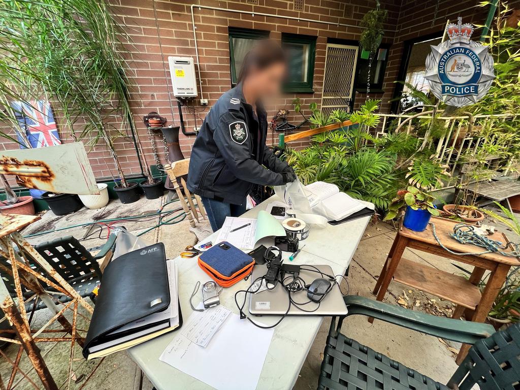 AFP officers search Samuel Frost's home in Adelaide's south. Picture: AFP