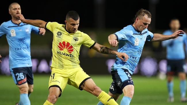 Phoenix player Jaushua Sotirio and Sydney FC’s Rhyan Grant compete for the ball in an A-League match.