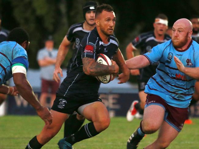 Quade Cooper bursts through a gap for Souths against Norths in Brisbane on Saturday.