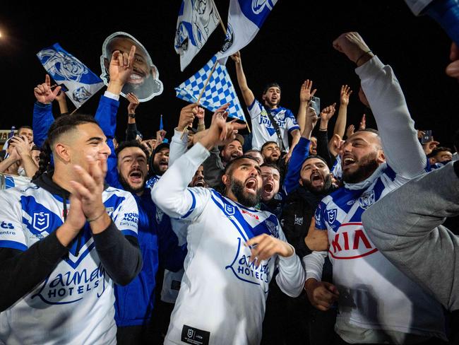 Bulldogs fans celebrate their teams win over the Dragons at Jubilee oval on Saturday night. Photo: Tom Parrish