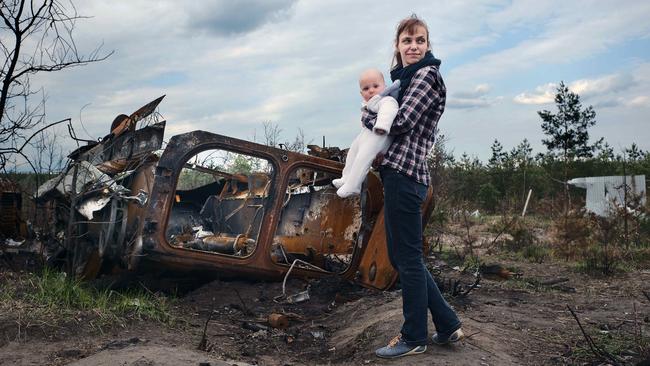 Kseniia Bondruchuk with her baby boy Anton at the Russian tank graveyard on the outskirts of Kyiv.Picture: Gary Ramage