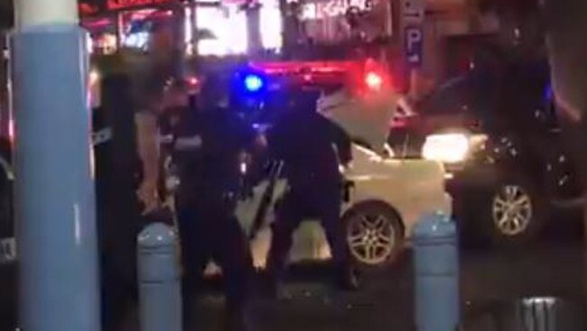 Police surround the car in Hindley St as the car stopped.