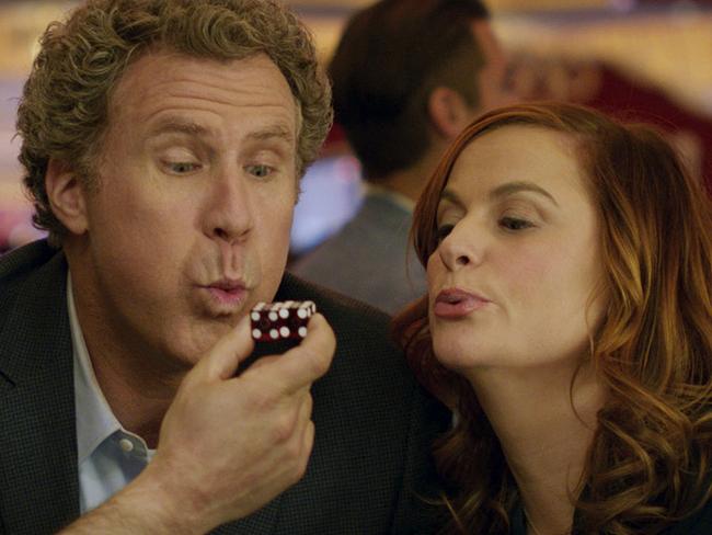 This image released by Warner Bros Pictures shows Will Ferrell, left, and Amy Poehler in a scene from, "The House." (Warner Bros. Entertainment via AP)