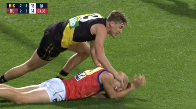 Tom Lynch pushes Alex Witherden's head into the ground.