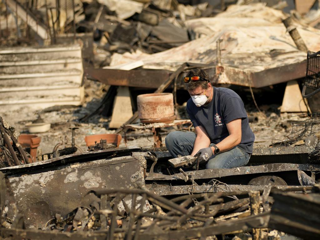 A man sifts through his mother’s fire-ravaged property in the Palisades fire. Picture: AP