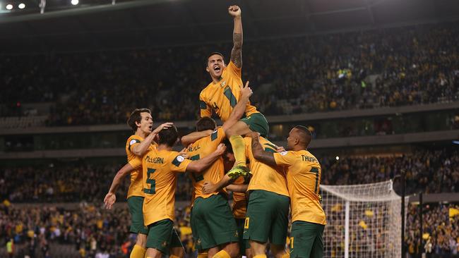 MELBOURNE, AUSTRALIA - JUNE 11: Tim Cahill (top) and the Australians celebrate after Lucas Neill of the Socceroos scored a goal during the FIFA World Cup Qualifier match between the Australian Socceroos and Jordan at Etihad Stadium on June 11, 2013 in Melbourne, Australia. (Photo by Scott Barbour/Getty Images) Picture: Images Getty