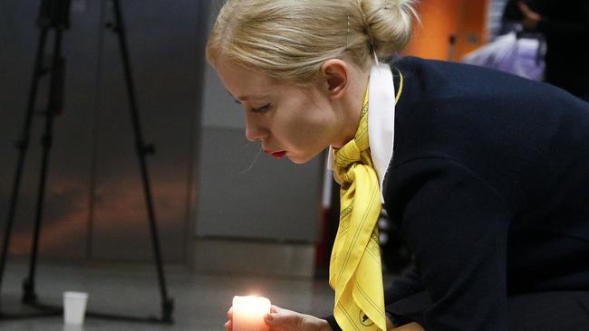 A colleague of the flight crew members of the Ukrainian 737-800 plane that crashed on the outskirts of Tehran lights a candle at a memorial inside Boryspil international airport at Kiev, Ukraine Picture: AP