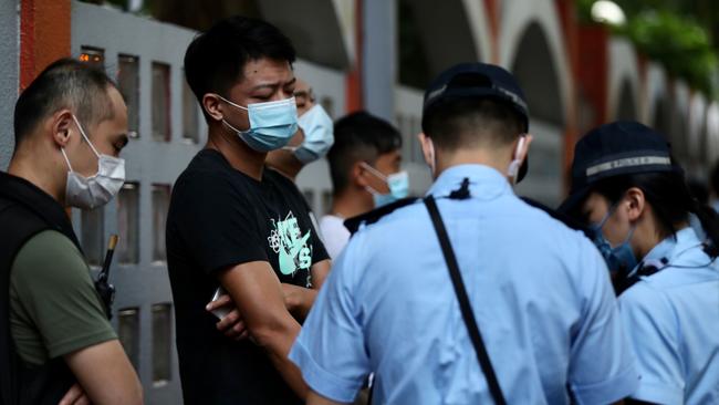 Police stop pedestrians as they patrol to deter protests during China's National Day in Hong Kong on Thursday. Picture: AFP