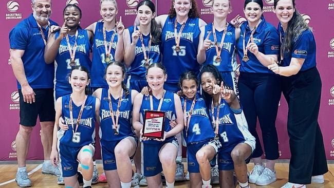 The Rockhampton Cyclones celebrate after winning Division 2 of the state under-14 girls basketball championships played in their home city.
