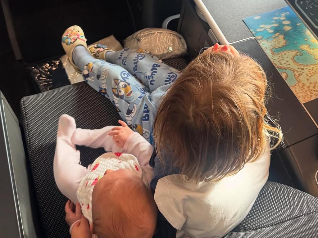 Becky Cummins shares a picture of four-month old daughter Edith and three-year-old son Albie sitting together in business class on the flight. Picture Instagram